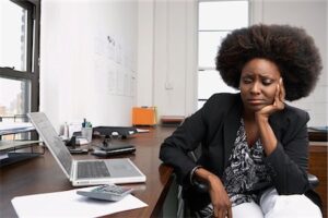 Woman at desk upset. solar tarot